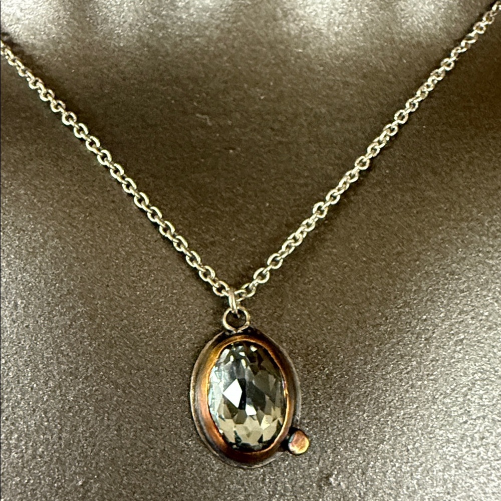 Ananda Khalsa Sterling Silver necklace with blue topaz in 22k rose gold frame.